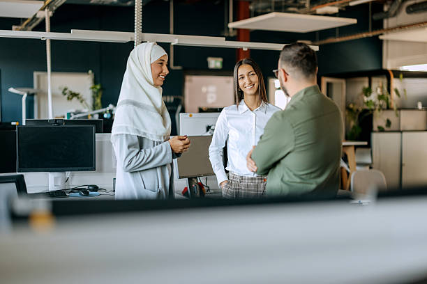 istock Group of colleagues talking at the office 2247137280