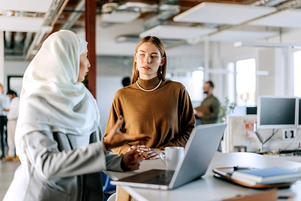 istock Two female colleagues using laptop at office 2247137297