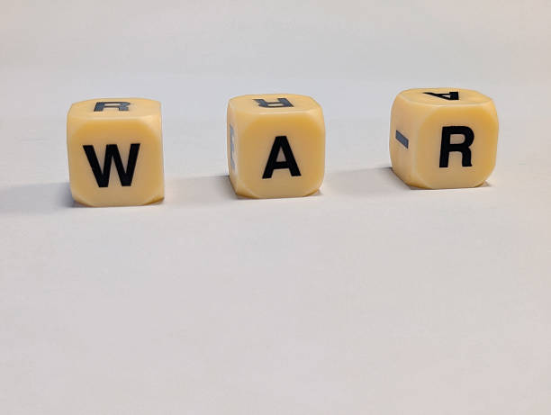 istock three letter dice spelling the word WAR on a white minimal background 2247137743
