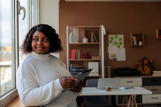 istock Black Businesswoman Using Digital Tabelt in Home Office 2247138076