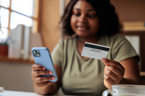 istock Black Professional Using Smartphone And Card At Home 2247138704