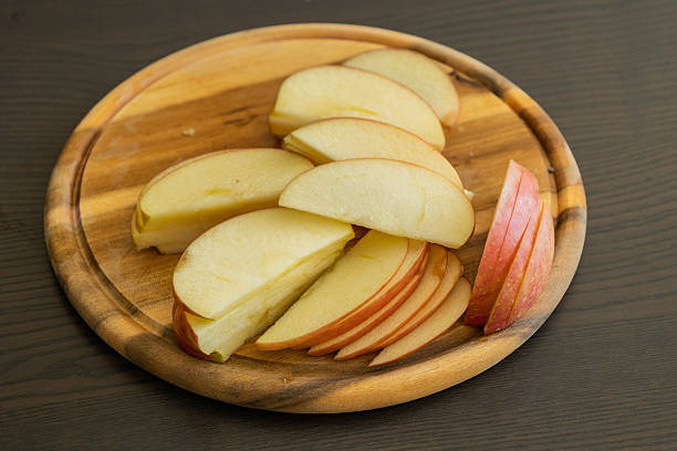 istock fresh apple slices arranged on wooden board kitchen prep 2247139456