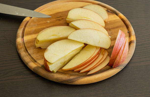 istock fresh apple slices arranged on wooden board kitchen prep 2247139661