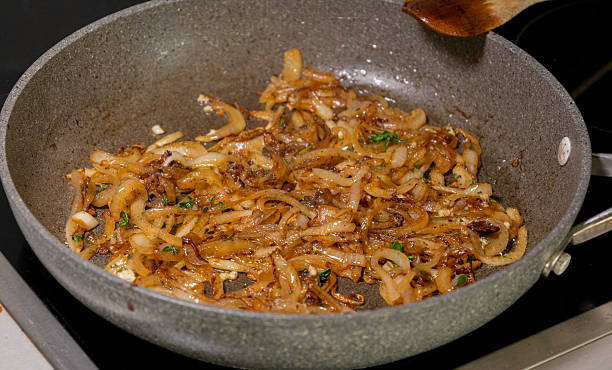 istock caramelized onions cooking in frying pan 2247139794