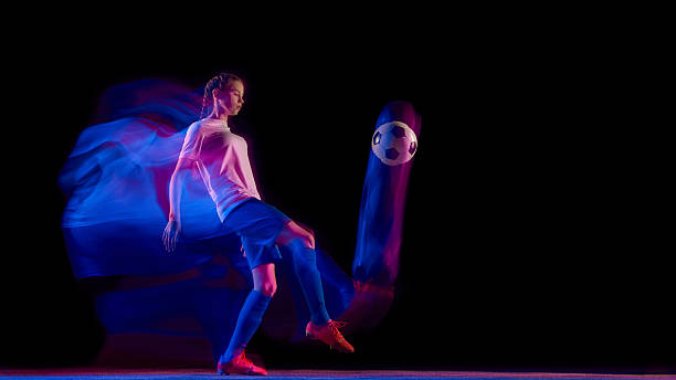 istock Football player performing ball control kick in colorful motion. 2247140427