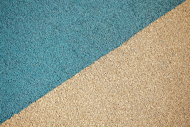 istock Granulated sports and playground surface in blue and beige colors, textured material pattern. Real photo 2247140919