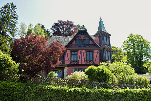 Le Hohwald, France – May 29 2023: Red half-timbered house on Rue Principale in Le Hohwald, Alsace, France. The traditional Alsatian architecture and village setting highlight the characteristic style of this mountain commune.