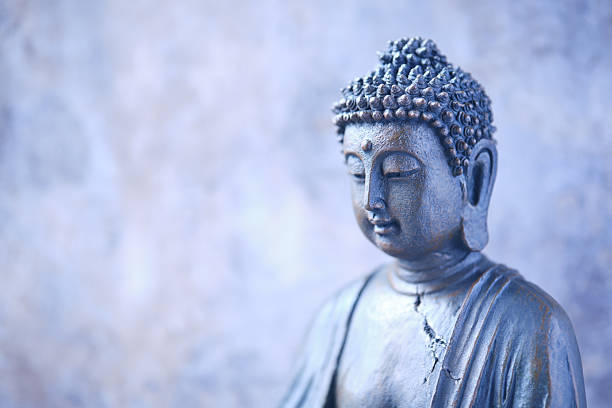 istock Meditating Buddha Statue on dark background. Soft focus. Close up. Copy space. 2247142183