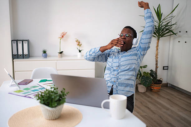 istock Tired man yawning and stretching during home office work 2247143475