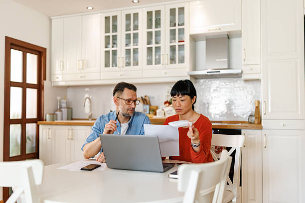 istock Couple going through financial statements at home 2247143687