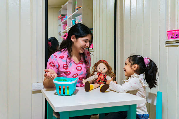istock Speech therapist working with girl during speech therapy session 2247143857
