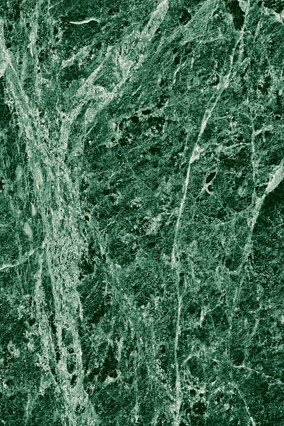 istock Real closeup of dark green marble stone texture surface background. Design pattern with high resolution for luxury home decoration. Abstract matt slab rock material. Front view of natural tiles stone surface. 2247144794