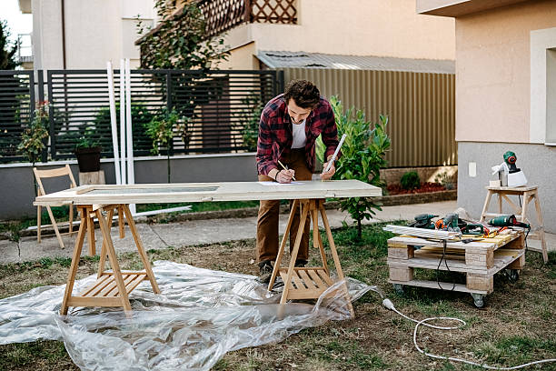 istock Man prepares a door for painting 2247145540