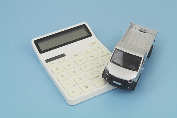 istock Lorry truck on calculator on blue background. 2247147071