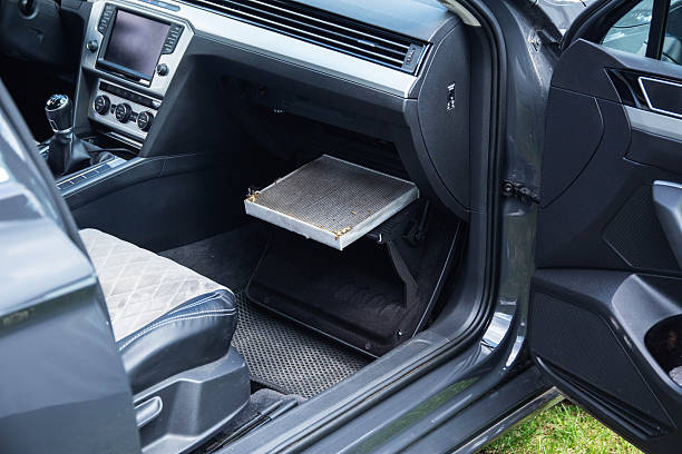 istock Replacing an old dirty cabin filter with a new one. Car maintenance, close-up 2247147853