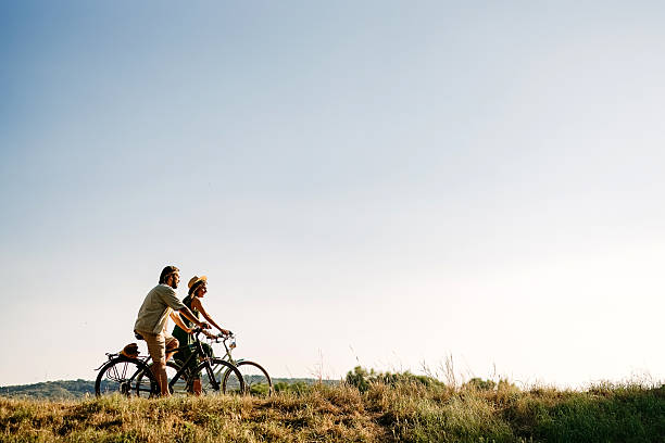 Couple is riding bicycles on a beautiful sunny day in nature