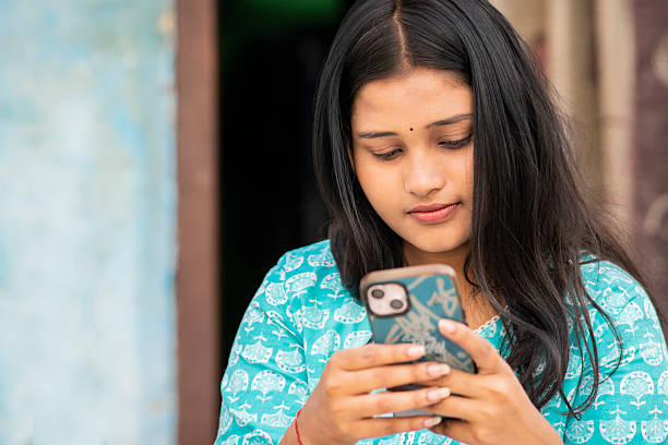 istock Happy Indian young woman using a smartphone. 2247148574