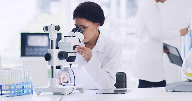 istock Microscope, research and sample with woman in lab for chemical study, medical and molecule. Microbiology particles, discovery and vaccine experiment with scientist in clinic for cure and pharmacy 2247149023