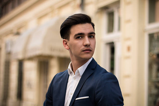 istock Young and elegant businessman on the street. 2247149721