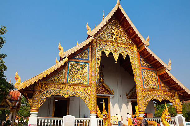 Front facade and entrance of Wat Phra Singh in Chiang Mai city. Facade and gable are golden ornated. King Ananda Mahidol (Rama VIII), the older brother of King Bhumibol Adulyadej (Rama IX), gave the temple the status of Royal temple of the first grade