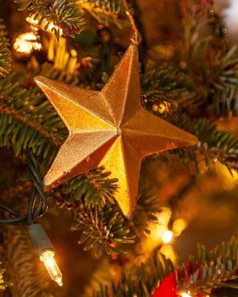 istock Close-up Gold Star Ornament  Illuminated Christmas Tree Interior Decor 2247154098
