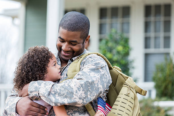 istock Soldier happily embraces daughter at home after returning from deployment 2247154954
