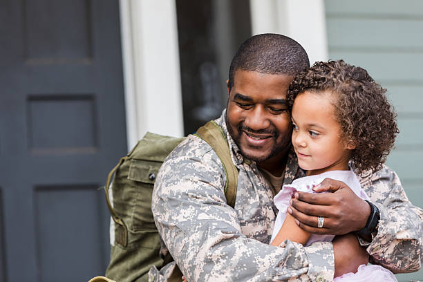 istock Father in uniform embraces daughter affectionately outside home with heartfelt connection 2247155036