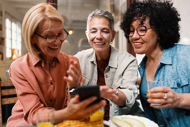 istock Middle-Aged Friends Enjoying Brunch While Viewing a Dating App Together 2247157886