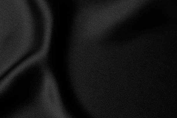 istock Black silk satin. Shiny smooth fabric. Soft folds. Luxury background with space for design. Flat table, top view 2247158307