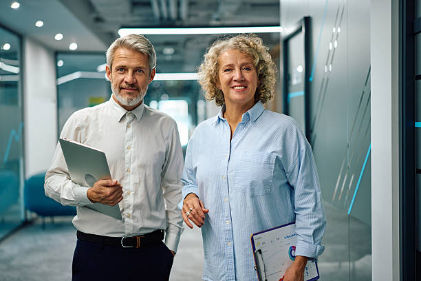 istock Business colleagues smiling while walking in modern office 2247160101