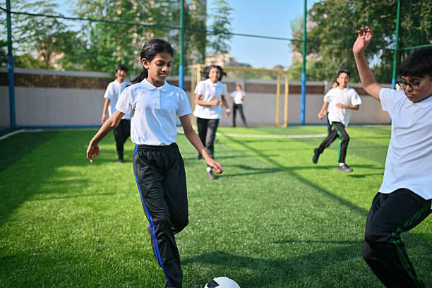istock Girl Students compete actively in a soccer match. 2247160428
