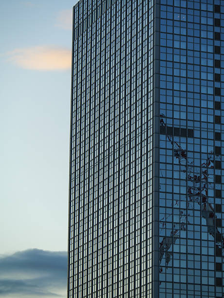 A Tall Urban Tower Against Clouds, a Glimpse Of A Modern Skyscraper.