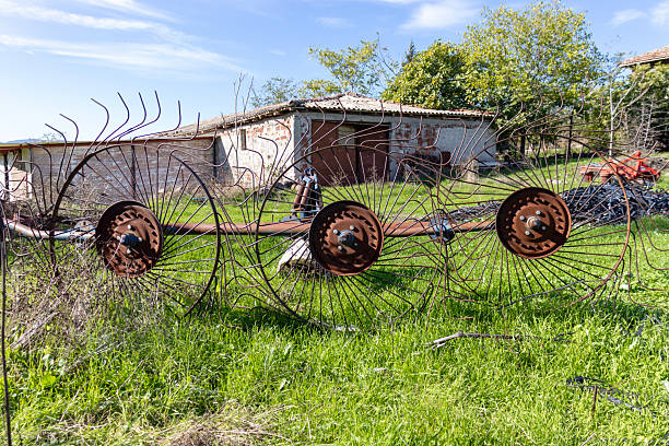 Agricultural harvester, old-fashioned technology, in a village setting