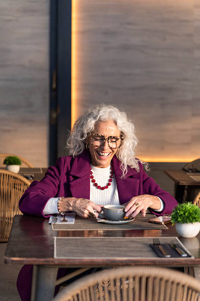 istock Mature woman laughing enjoying coffee in cafe 2247163708