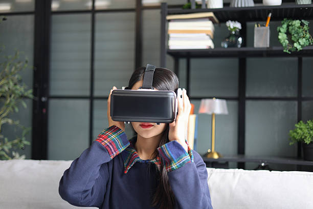 istock Young asian woman wearing virtual reality glasses. VR headset. VR concept. 2247163738