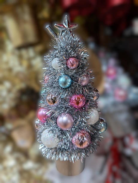 istock Decorative silver Christmas tree with colorful ornaments on display in a holiday setting 2247163903