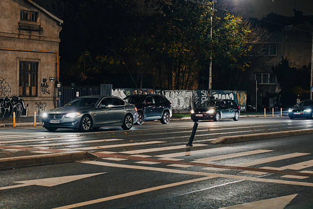 Bucharest, Romania - 11/15/2025: Car traffic on the main boulevard at Victoria Square at night in Bucharest downtown
