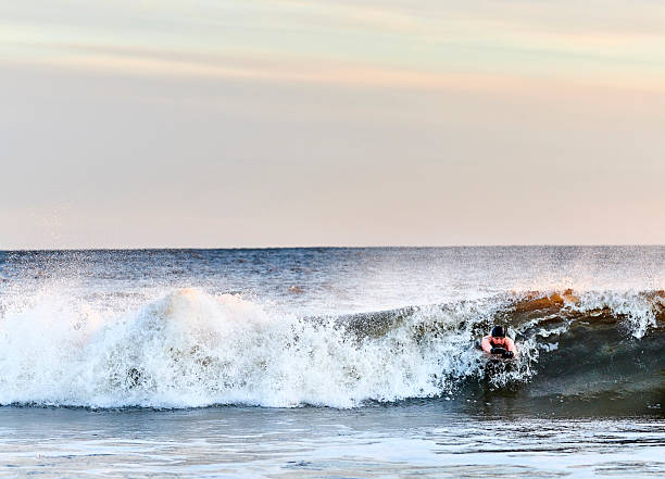 Large ocean wave and a surfer riding the front of the wave\n\nTaken in Santa Cruz, California, USA