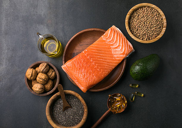 Healthy red fish with avocado, chia seeds, and nuts rich in omega-3, top view.