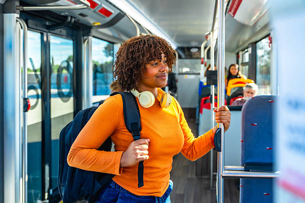 istock Young woman commuting on bus with headphones and backpack 2247168221