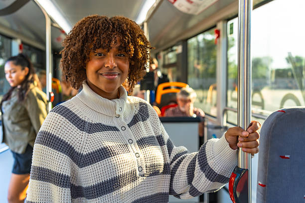 istock Young woman commuting on public bus smiling at camera 2247168305