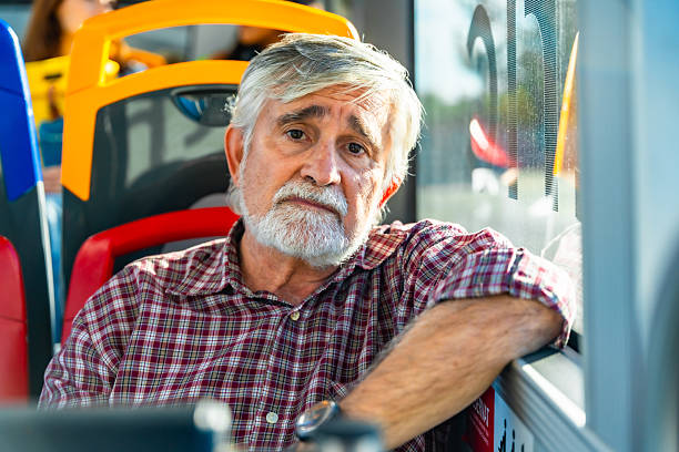 istock Senior man riding public bus looking thoughtful 2247168310