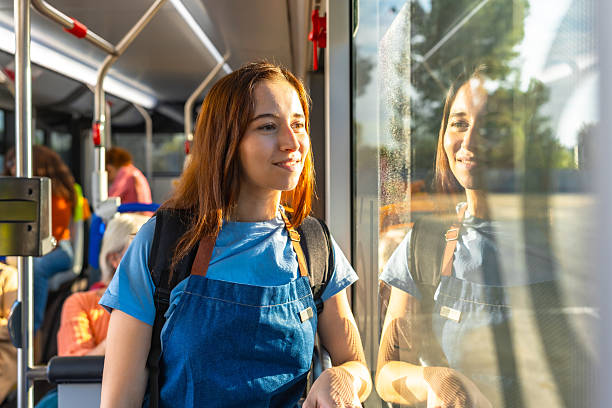 istock Young woman smiling while commuting on a city bus 2247168364