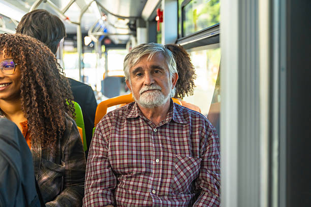 istock Senior man riding public bus, commuting in city 2247168462