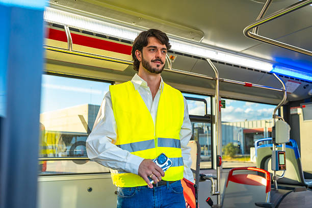 istock Man wearing safety vest standing on public bus 2247168682