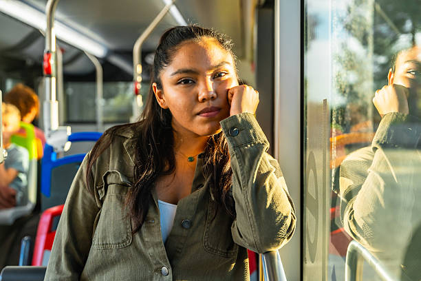 istock Young woman commuting on bus reflecting in window 2247168901