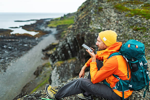 istock Mid adult man resting and using mobile voice assistant 2247169635