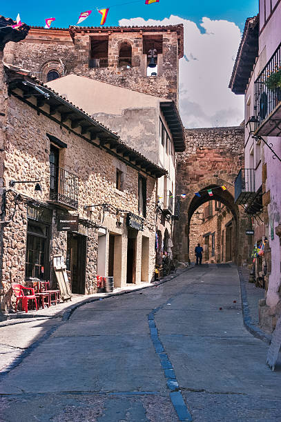 istock Medieval Spanish village street with stone archway 2247169869