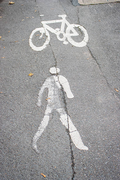 istock white paint symbol on tarmac road footpath for multiuse pavement pedestrians and cyclist 2247170643