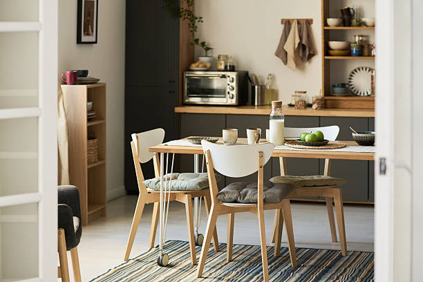 istock Modern Scandinavian Kitchen Interior Featuring Wooden Dining Table and Chairs 2247171291